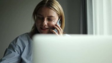 İşletme genç bayan çalışanı telefonda konuşuyor ve ofis işyerindeki uygulama bilgisayarını kullanıyor. Çoklu görev yöneticisi cep telefonuyla konuşuyor, müşteriyi arıyor, danışmanlık yapıyor. Yüksek