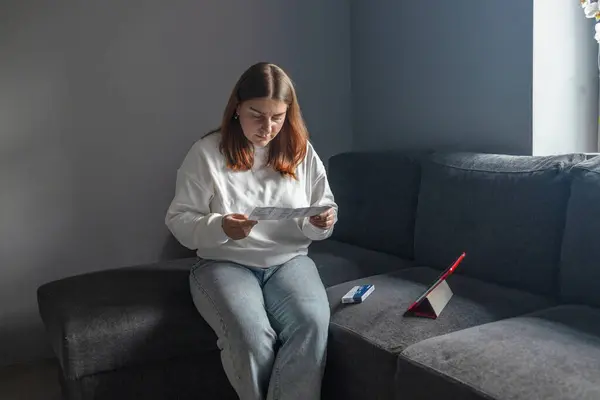 stock image Caucasian woman using rapid antigen test kit for self test COVID-19 epidemic at home. Adult female unpacking a swab for inserts into her nose. COVID-19 coronavirus pandemic protection concept. 