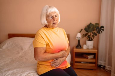 Abdominal pain in elder senior mature aging woman with stomachache illness from stomach cancer, irritable bowel syndrome, Indigestion, Diarrhea, gastroparesis or GERD  clipart