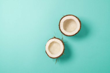 Mavi arka planda olgun hindistan cevizi. Pop sanat tasarımı, yaratıcı yaz konsepti. Pankart. Minimum düzlükte hindistan cevizinin yarısı. Yüksek kalite fotoğraf