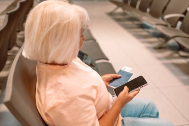 Qr code, check in and man with a phone for a ticket, airplane booking and information at airport. Travel, website and hand of a businessman reading a barcode on a mobile for a work trip or vacation