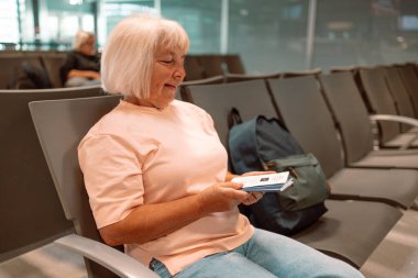 Qr code, check in and man with a phone for a ticket, airplane booking and information at airport. Travel, website and hand of a businessman reading a barcode on a mobile for a work trip or vacation