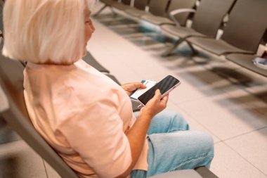 Qr code, check in and man with a phone for a ticket, airplane booking and information at airport. Travel, website and hand of a businessman reading a barcode on a mobile for a work trip or vacation