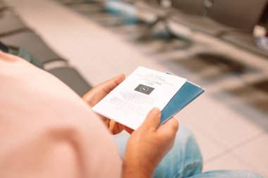 Qr code, check in and man with a phone for a ticket, airplane booking and information at airport. Travel, website and hand of a businessman reading a barcode on a mobile for a work trip or vacation