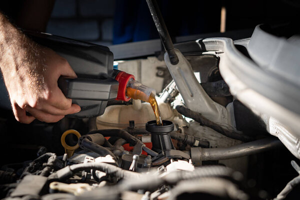 Engine oil is pouring into the engine. High quality photo