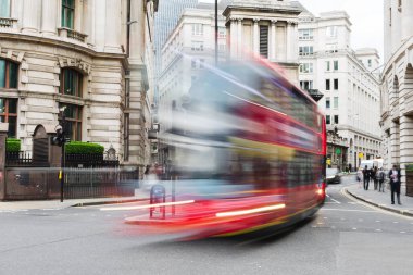picture of a city street scene in London UK with a London bus in motion blur