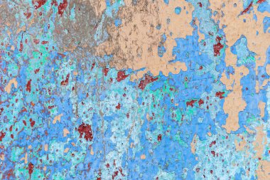 background texture of an old weathered wall with cracked multi colored paint