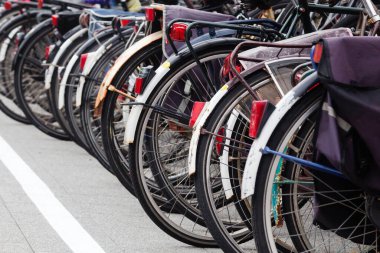 image of a row of old bicycles at a bicycle station