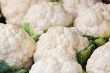 image of a bulk of white cauliflower at a market stall
