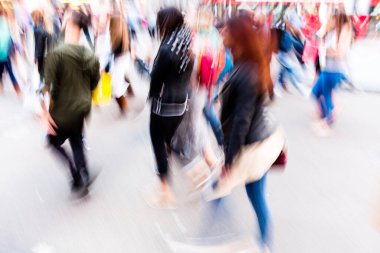 creative blurred image of crowds of people on the move in the busy city