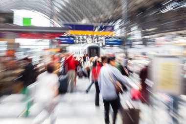 abstract picture with camera made zoom effect of crowds of people at a train station