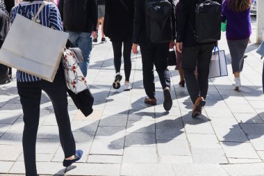 Şehirde yürüyen bir kalabalığın fotoğrafı.