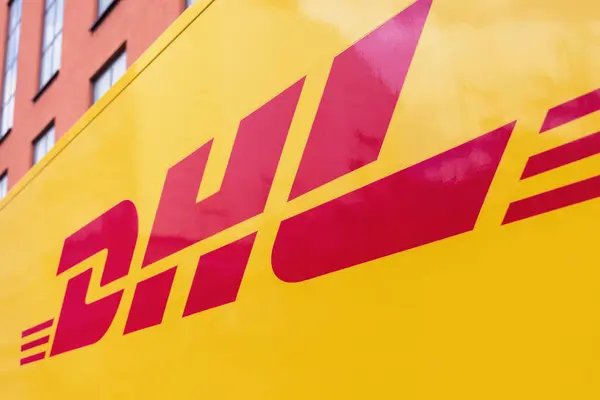 stock image Munich, Germany - April 05, 2023: Logo of the DHL company on a yellow delivery van. DHL is an American-founded German logistics company, delivering over 1.8 billion parcels per year