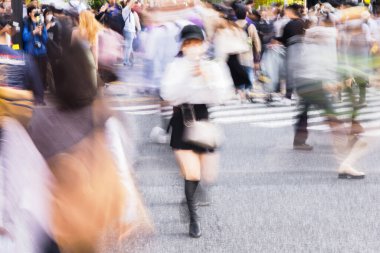 Tokyo, Japonya 'daki ünlü Shibuya Geçidi' nden geçen kalabalığın hareket bulanıklığı etkisi.