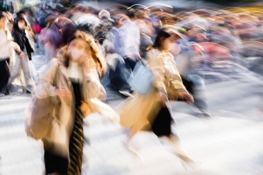 Tokyo, Japonya 'daki ünlü Shibuya Geçidi' nden geçen kalabalığın hareket bulanıklığı etkisi.