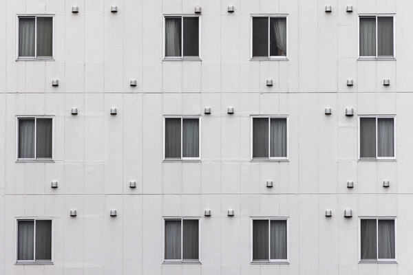 Picture of a facade of a building with rows of windows in Japan