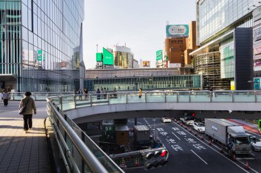 Tokyo, Japonya - 11 Nisan 2023: Shibuya 'daki yaya üstgeçitleri, kimliği belirsiz insanlarla dolu. Shibuya büyük bir ticaret ve finans merkezidir.