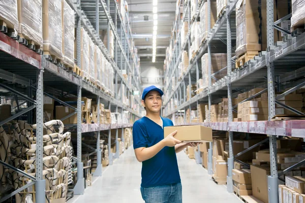 Asian Man Holding Bundles Paper Box Stock Shelves Himself Warehouse Stock Image