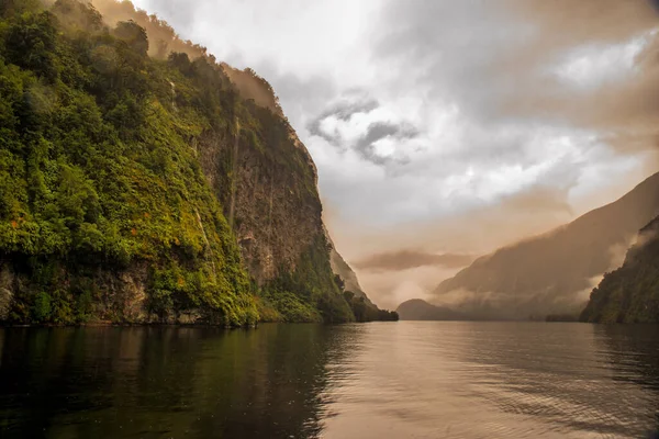 Erie atmosphere sailing through a very calm but cloudy Doubtful Sound in Fiordland national Park