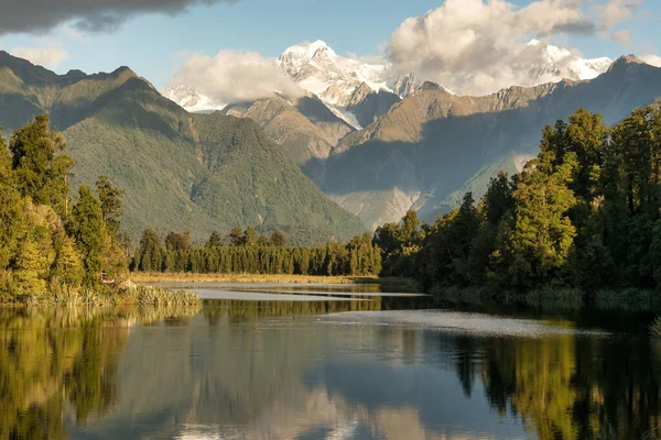 The scenic iconic Matheson Lake in Fox Glacier with the Southern alps in the background in the West Coast New Zealand