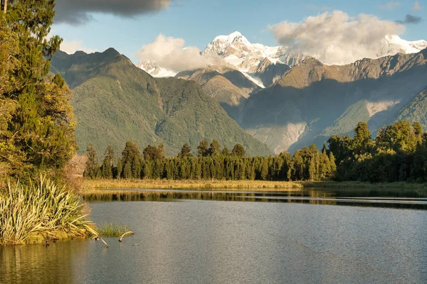 The scenic iconic Matheson Lake in Fox Glacier with the Southern alps in the background in the West Coast New Zealand