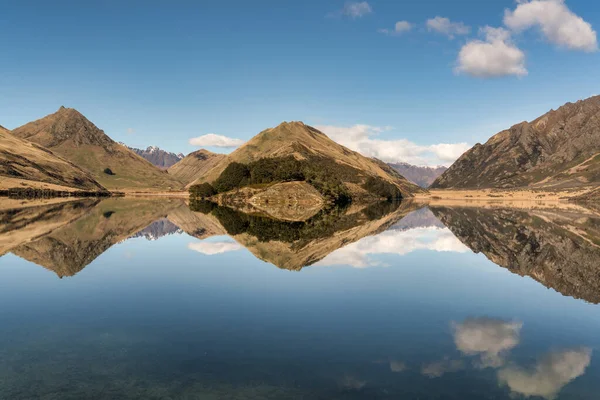 stock image Reflections of the hills and cloudscape  on the remote Moke Lake near Queenstown  New Zealand