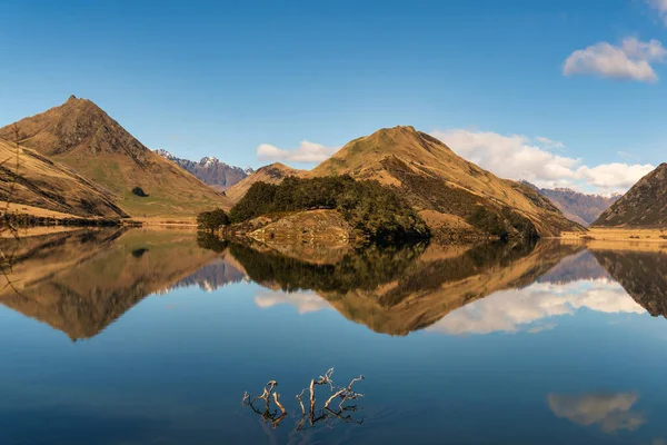 Crystal clear mountain reflection on the very still water of moke lake in the mountains near Queenstown