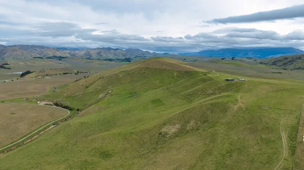 The rolling green hills and valleys comprising agricultural and farm countryside in heartland New Zealand