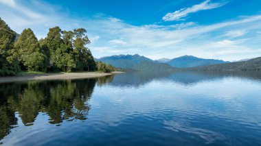 Aerial footage of the alpine lake surrounded by the Southern Alps mountain range clipart