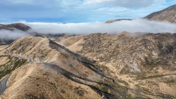 stock image Aerial view of the mountains shrouded in cloud in Torlesse Tussocklands Park