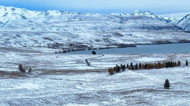 Drone perspective of snow covered agricultural land between Tekapo and pukaki clipart