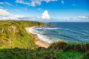 Rugged beach and costal scene on the cliffside walk by the ocean clipart