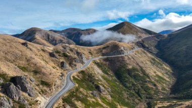 The great alpine highway SH 73 heading across the mountains at Torlesse Park to the West Coast of New Zealand clipart