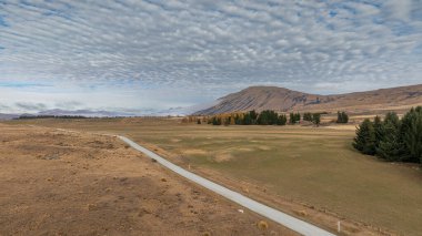 Drone  view of the Ashburton highlands with a river an lake in the dry arid terrain on the way to Lake Heron clipart