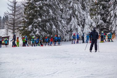 27.01. 2022 . Zuberec Ski Park. Slovakia. Western Tatras. Ski children school, teaching children to ski. Concept of winter vacation,  family rest , healthy lifestyle, children's entertainment, early learning