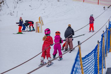27.01. 2022 . Zuberec Ski Park. Slovakia. Western Tatras. Ski children school, teaching children to ski. Concept of winter vacation,  family rest , healthy lifestyle, children's entertainment, early learning