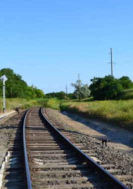 Railroad passing by forest sleeper rails