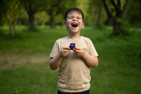 Funny Boy Laughing Sunny Field Park Child Takes Colorful Spinner — Zdjęcie stockowe