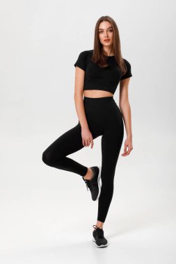 Fitness woman. Athletic girl on the gray background