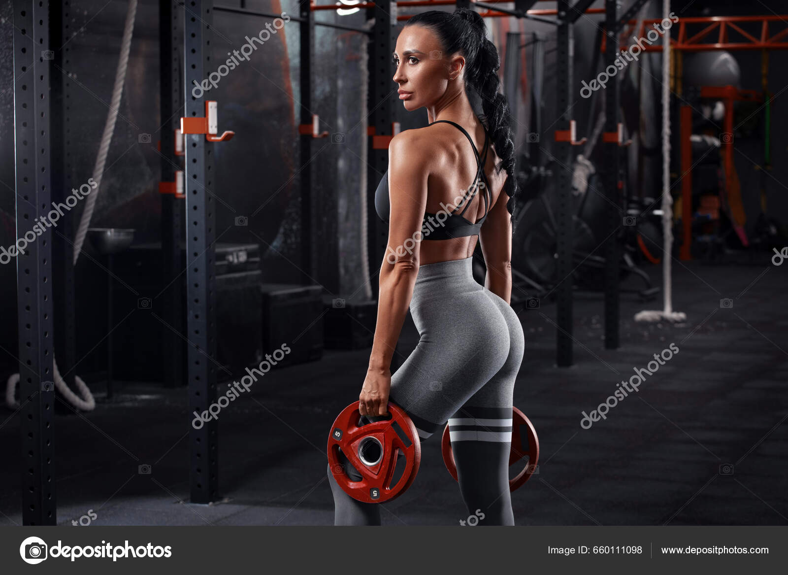 Fitness woman doing pull-ups exercise for back muscles, working