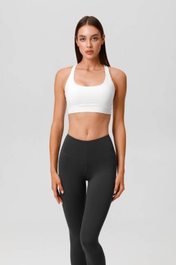 Fitness woman. Athletic girl on the gray background