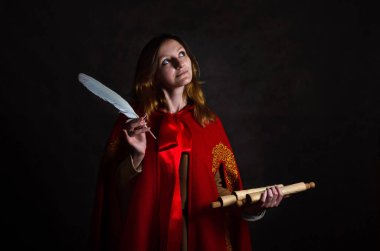 A woman in a vibrant red cloak, adorned with intricate golden embroidery, holds a feather quill and an ancient-looking scroll. Her thoughtful expression and the dark, mysterious background suggest her deep engagement with the arcane arts and the writ clipart