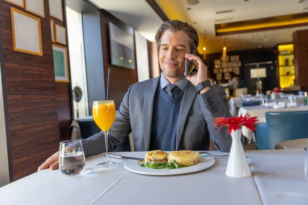 Handsome businessman using smartphone in the restaurant