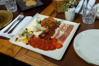 Selection of dried meat products, beef prosciutto, flat sausage, cheese
