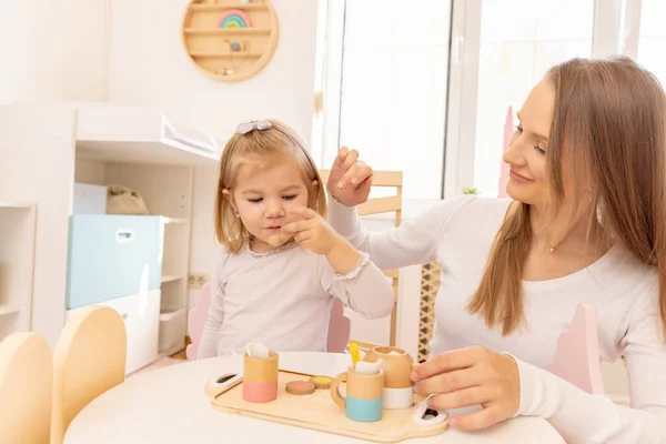 Young Girl Playing Her Mother Wooden Toys Eating Drinking — Stock Photo, Image