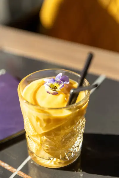Smoothie decorated with flower served in a bar