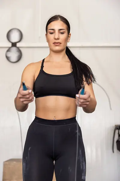 Fitness woman jumping on skipping rope in the gym