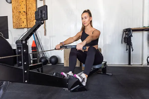 Woman doing exercises on a rowing machine