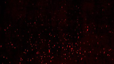 Parlak kıvılcımlar hızla yukarı doğru uçar koyu bir arka planda, parlak kırmızı renkler gösterir