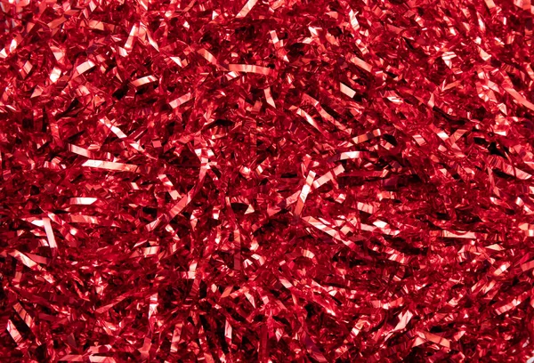 Red shiny metallic ribbon background, lot of copy space, studio shot. Christmas or New Years background.